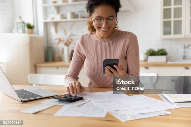 Smiling Young Woman Satisfied With Online Payment Mobile Service Stock Photo - Download Image Now