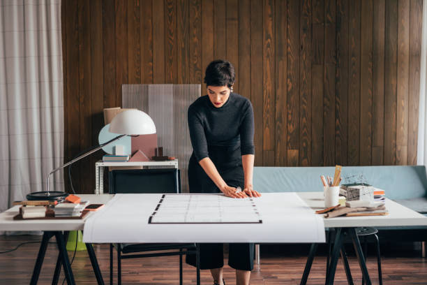 istock Devoted Female Architect Working on an Architectural Drawing of a Building 1329929710