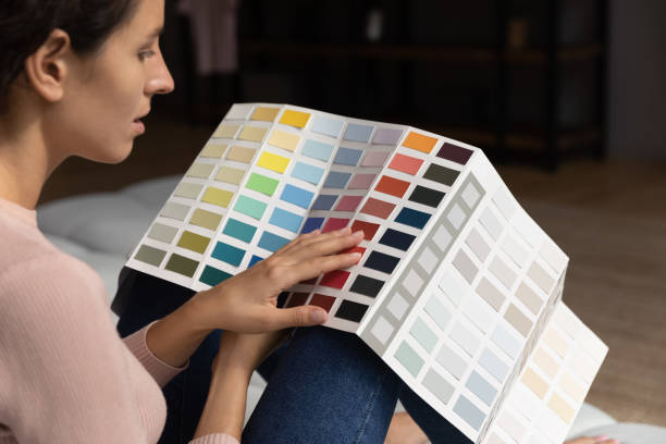 istock Creative young woman choosing colors for apartment renovation. 1329930114