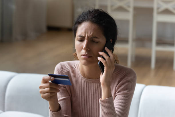 istock Dissatisfied young female hispanic client calling bank support. 1329930131