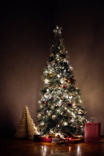 istock MÐµrry Christmas: Decorated, Glowing Christmas Tree with Presents Under it 1329930773