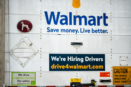 Lexington, USA - May 27, 2021: Highway road in Virginia with truck delivery vehicle for Walmart and sign for hiring drivers application on online website