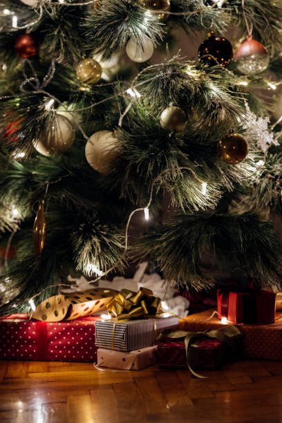 istock Merry Christmas: Close up Shot of Christmas Presents under a Decorated Tree 1329930802