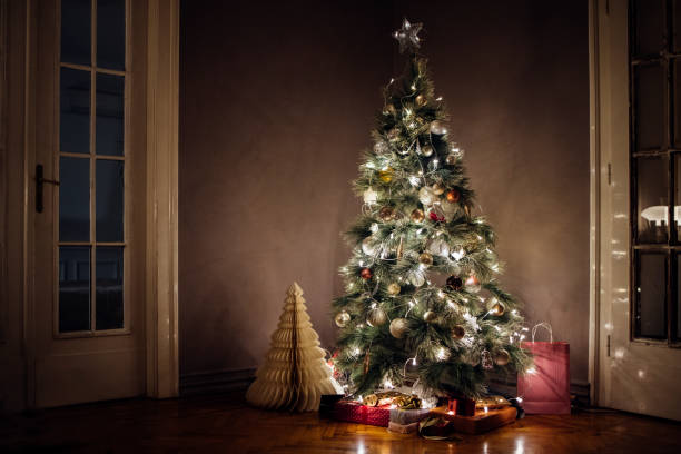 istock Merry Christmas: Decorated, Glowing Christmas Tree with Presents Under it 1329930813