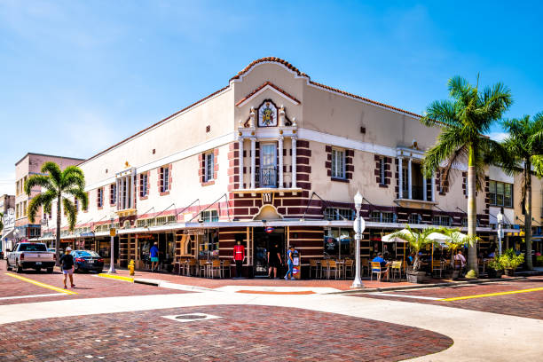 Fort Myers, Florida city with people outside restaurant United Ale House in historic building Fort Myers, USA - April 29, 2018: Florida gulf of mexico city downtown with people outside restaurant United Ale House in historic building fort myers beach photos stock pictures, royalty-free photos & images