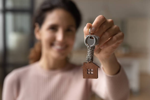 istock Happy young woman showing keys to camera. 1329931133