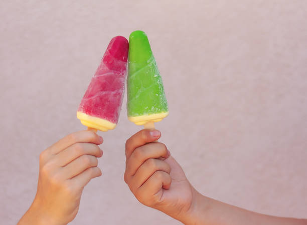 frozen or ice cream on a stick are held in hands