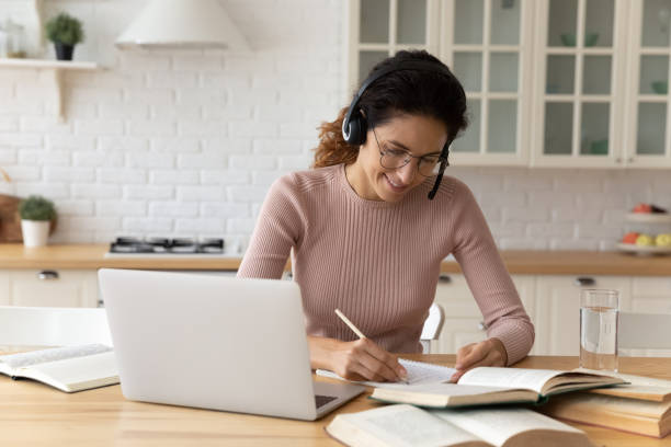 istock Smiling young woman involved in online education. 1329931965