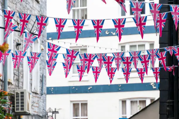 Photo of British Union Jack flag triangular hanging in preparation for a street party. Festive decorations of Union Jack bunting.