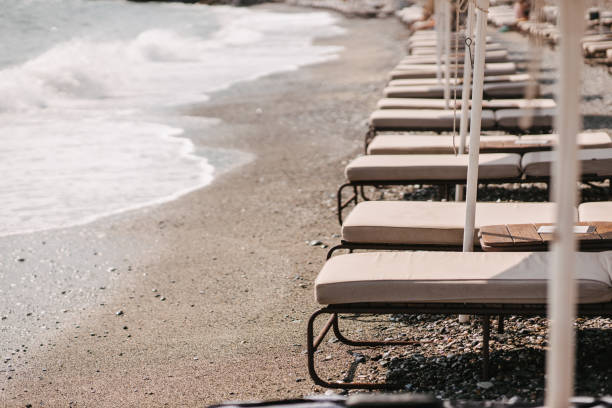 istock Lounge chairs and an umbrellas in a row 1329934753