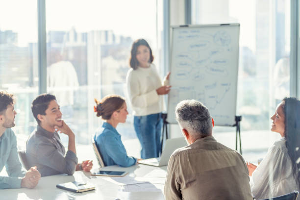 istock Business people watching a presentation on the whiteboard. 1329935275