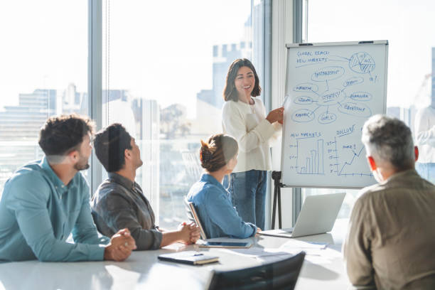 istock Business people watching a presentation on the whiteboard. 1329935276