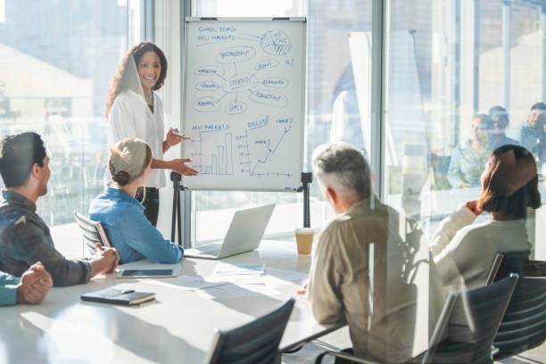 istock Business people watching a presentation on the whiteboard. 1329935280