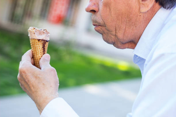 istock Happy senior Man eating ice cream 1329935330