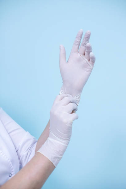 istock doctor's hands in medical gloves on a turquoise background 1329935406