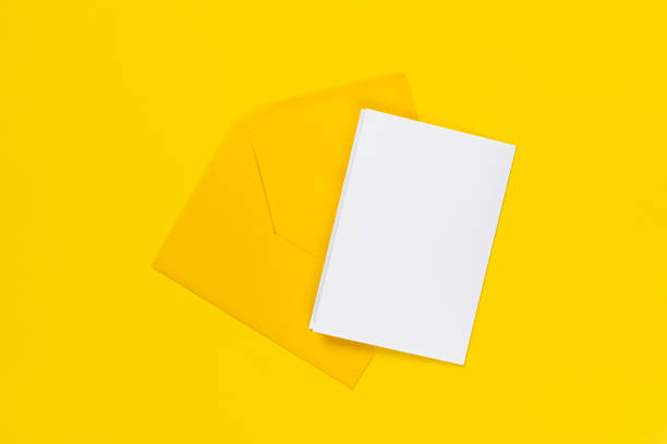 istock Blank white card with yellow envelope isolated on yellow background. Template or mock up. Banner with copy space 1329935990
