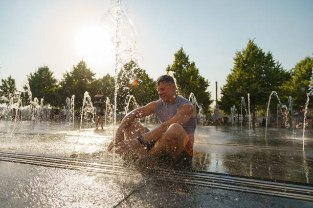 istock Man sitting among fountains 1329936080