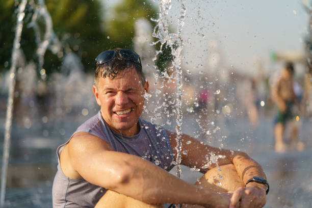 istock Man sitting among fountains 1329936089