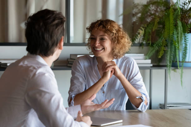 istock Excited colleagues chatting discussing project ideas sitting at table 1329936135