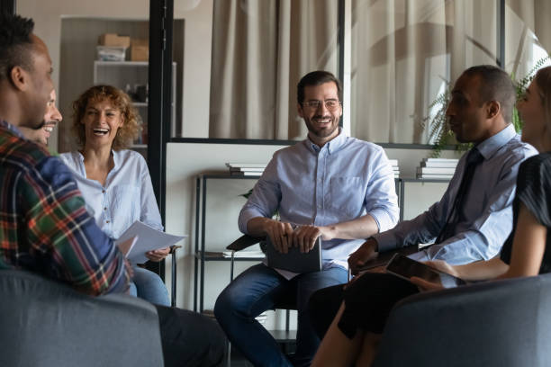 istock Happy diverse colleagues having fun at briefing, laughing at joke 1329936164