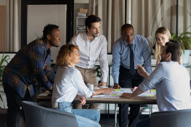 istock Smiling diverse colleagues brainstorming working with financial documents together 1329936165