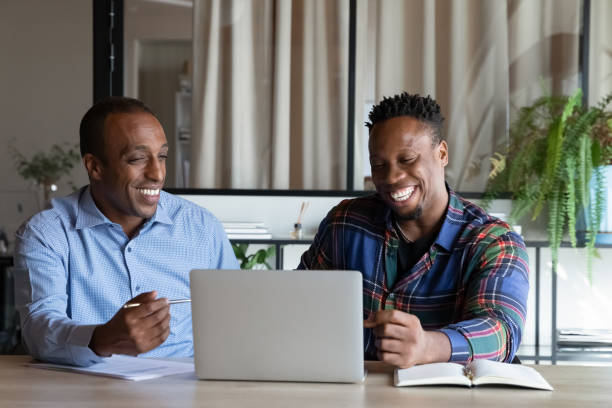 istock Excited two African American employees working on online project together 1329936201