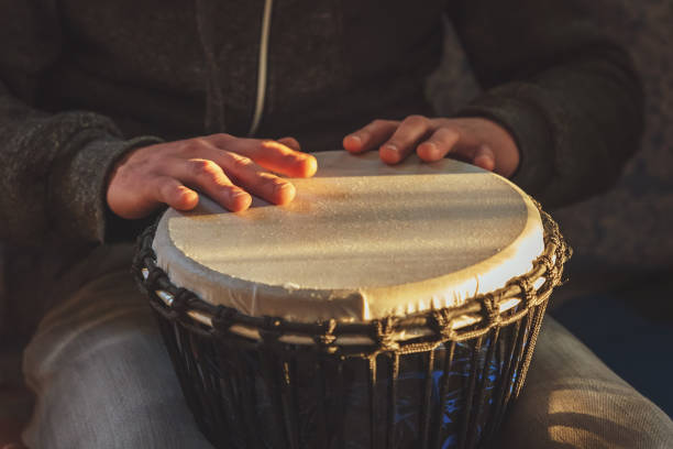 istock The drummer plays the ethnic percussion musical instrument djembe 1329936257