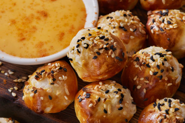 Everything Bagel Spiced Pretzel Bites Soft and Chewy Pretzel Bites with Everything Bagel Seasoning and Cheese Dip cheese sauce stock pictures, royalty-free photos & images