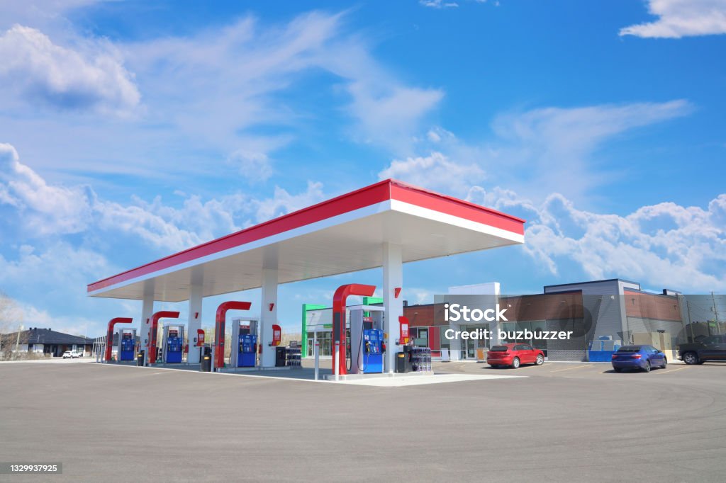 Modern Service Station in a Sunny Day Modern Service Station with convenience store and a few cars, in a Sunny Day Gas Station Stock Photo