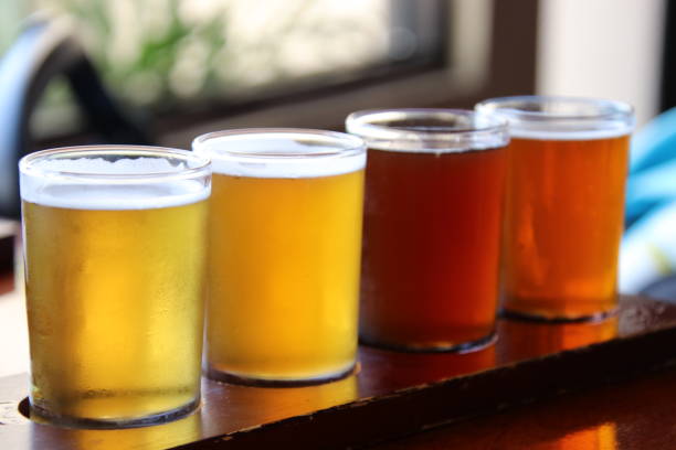 istock Beer flights samples in wood serving tray on pub table. 1329938887