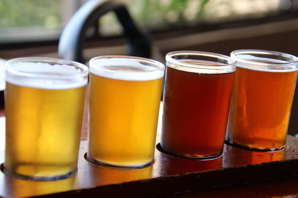 istock Beer flights samples in wood serving tray on pub table. 1329938953