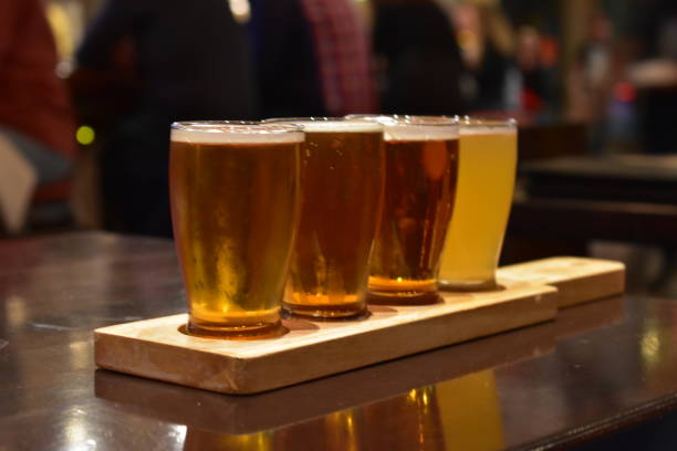 istock Beer flights samples in wood serving tray on pub table. 1329940348