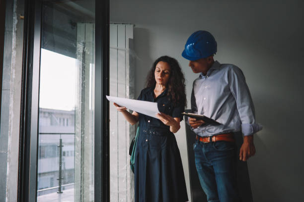 istock Architect colleagues inspecting the contruction site 1329941113