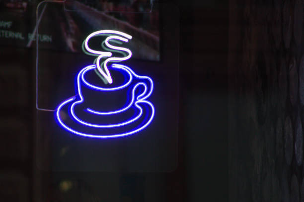 Vintage Neon Italian Sign at Night: “Caffe.” Red Lettering on Black Background.