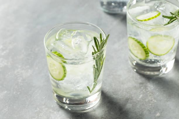 Refreshing Boozy Rosemary Gin and Tonic Refreshing Boozy Rosemary Gin and Tonic with Cucumber gin tonic stock pictures, royalty-free photos & images