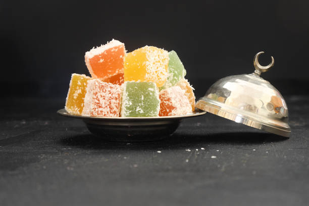 istock Turkish delight dessert in plate on black background 1329949054