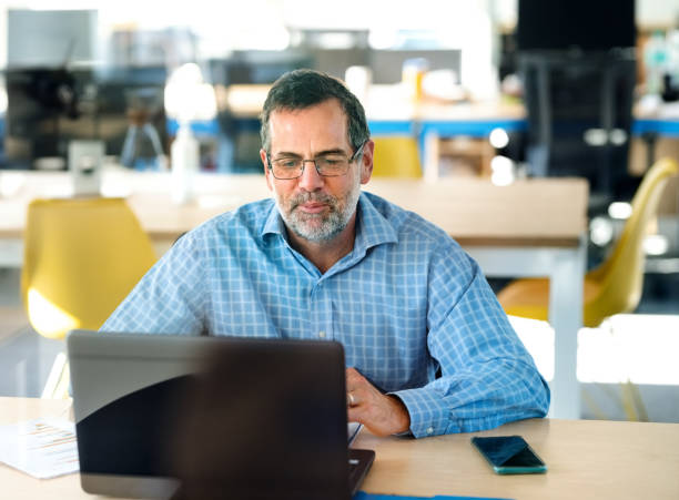 istock Mature professional video calling with laptop 1329949186