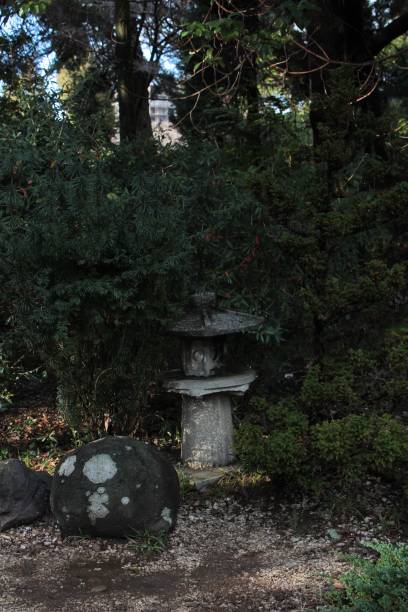 istock Small architectural objects in the Asian style on the background of greenery 1329949275