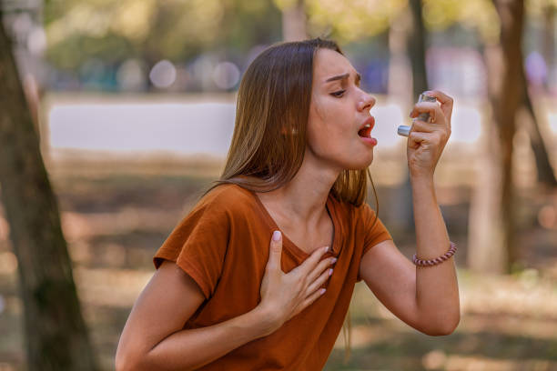 istock Beautiful Woman has Problems with the Respiratory System so She Uses an Inhaler. 1329950781