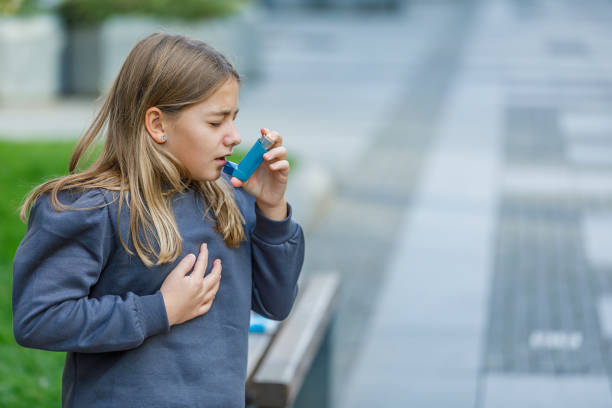 istock Cute Girl has Problems With Respiratory System so She Uses an Inhaler. 1329950788