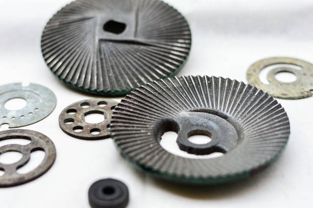 Close-up of metal gears and gear washers on light background.