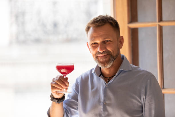 Adult man's portrait with cocktail stock photo