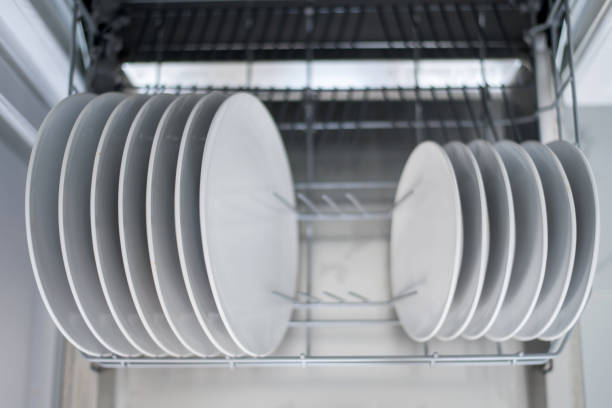 istock White flat plates are loaded into the dishwasher 1329957163