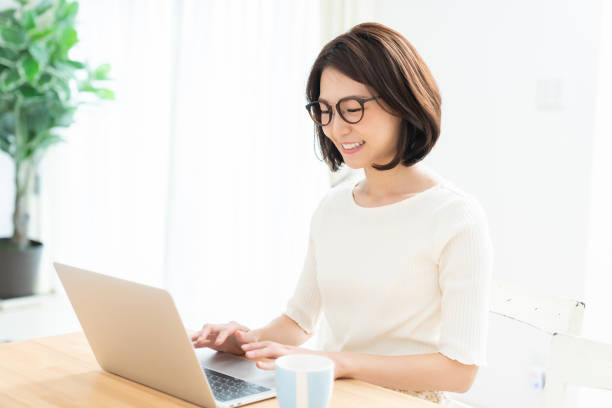 istock young asian woman using laptop 1329960136