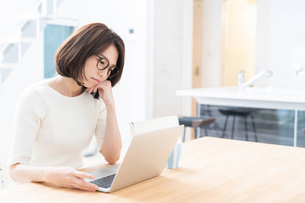 istock young asian woman using laptop,think, 1329960259