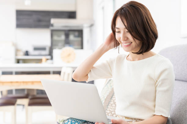 istock young asian woman using laptop 1329960304