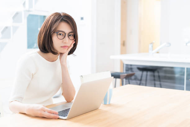 istock young asian woman using laptop,think, 1329960389