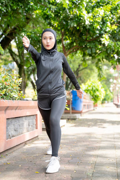 istock woman stretching her arm during exercising outdoor 1329960493