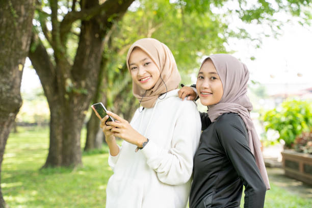 istock muslim friend using smartphone after exercising outdoor together 1329962957