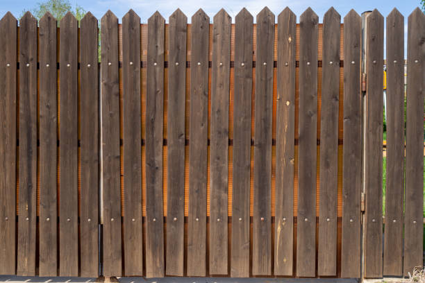 istock Wooden plank fence with metal rivets. Background with copy space 1329962972